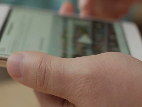 Man using his smartphone with to scroll a Instagram account feed, scrolling n Stock Footage 83594840