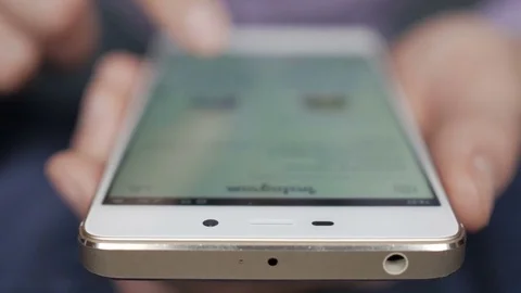 Man using his smartphone with to scroll a Instagram account feed, scrolling n Stock Footage 85046590