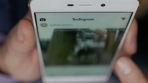 Man using his smartphone with to scroll a Instagram account feed, scrolling n Stock-Footage 85380724