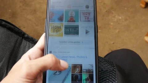 Man using his smartphone with to scroll a feed. 4K. Stock-Footage 204142798