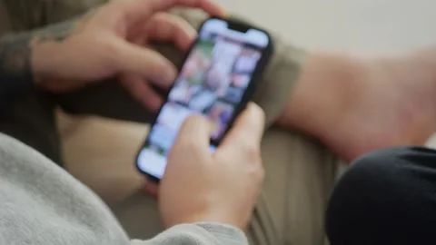 Man using his smartphone to scroll through an Instagram feed, browsing posts... Stock Footage 318177719