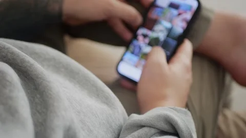 Man using his smartphone to scroll through an Instagram feed... Stock Footage 318177892