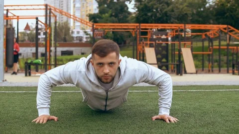 Man is using his strength to do push up Stock Footage 93821390