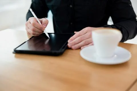 Man using his tablet with stylus. opy space screen on gadget. Cut close up view Stock Photos