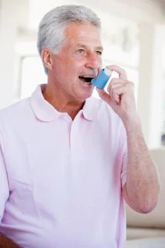 Man Using An Inhaler Stock Photos