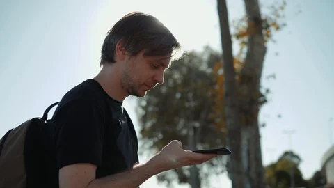 Man Using Internet Voice Search Technology On Mobile Phone recognition speech ai Stock Footage 97854616