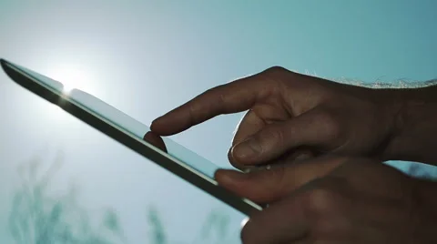 Man Using IPad On A Sunny Day Stock Footage 49331222