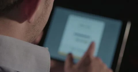 Man Using iPad Tablet Computer - Over Shoulder Shot 4k UltraHD Stock Footage 52560473