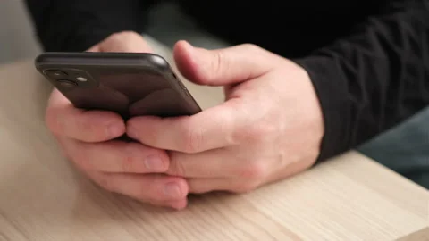 Man using iPhone 11 smartphone pressing finger, reading internet, typing text Video stock 237448257