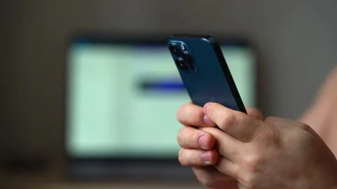 Man using iPhone 12 smartphone pressing finger, reading social media internet Stock Footage 169661365