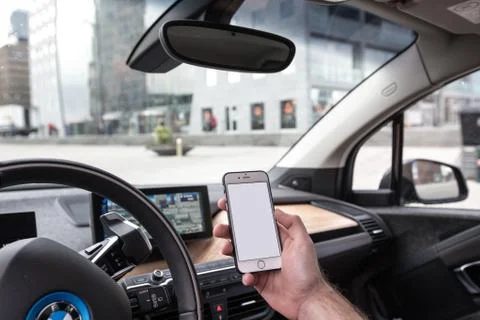 Man using iPhone in BMW i3 스톡 사진