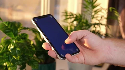 Man using iPhone XR smartphone viewing green screen green screen template Video stock 171299807