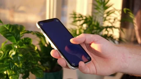 Man using iPhone XR smartphone viewing green screen green screen template Stock Footage 172753779