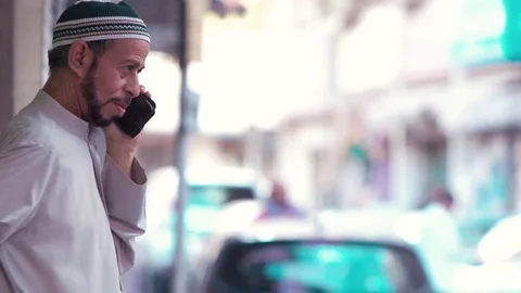 Man using the Islamic prayer cap, talking by the mobile - Bahrain Video stock 73312663
