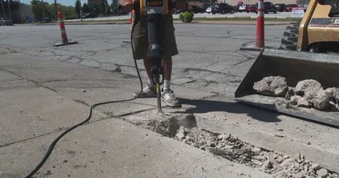 Man Using Jackhammer, Tilt Up Stock Footage 78584869