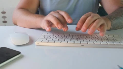 Man using keyboard and mouse at computer desk in front view, switching between Stock Footage 333768854
