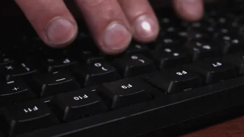 Man using keyboard of computer, close-up of fingers pressing function keys Video stock 205225492
