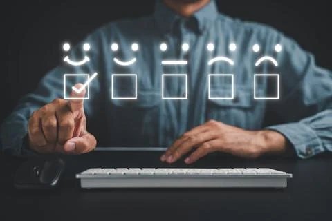 Man using keyboard computer finger touching rate smile face and evaluate Stock Photos