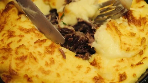 A man using a knife and fork cuts a potato and duck pie close up, Duck Stock Footage 326905610