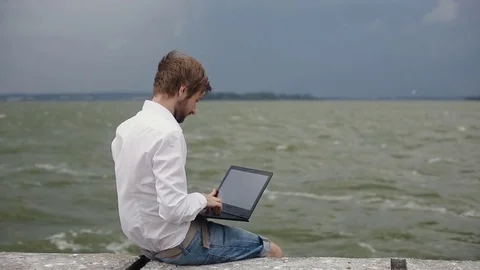 Man using laptop against the background of the storm Stock Footage 79569616