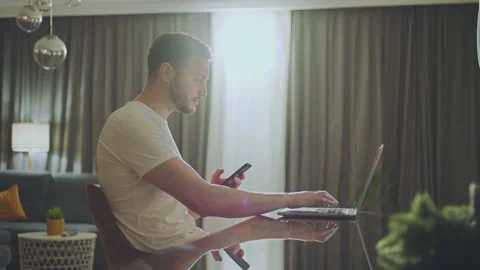 Man using laptop and mobile for work Video stock 234347585