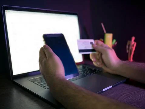 Man using laptop and mobile phone to online shopping and pay by credit card Stock Photos