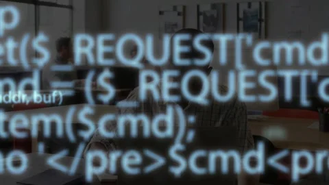 Man using laptop and notes, starting code overlay obscuring then fading, showing Stock-Footage 335762221