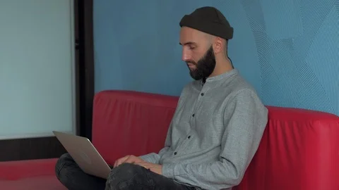 Man using laptop and phone at home Stock-Footage 86283999