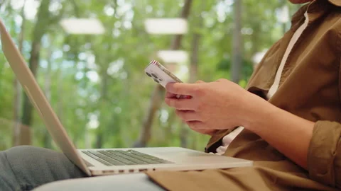 Man using laptop and smartphone close-up, coworking center. Young guy working Stock Footage 220199628