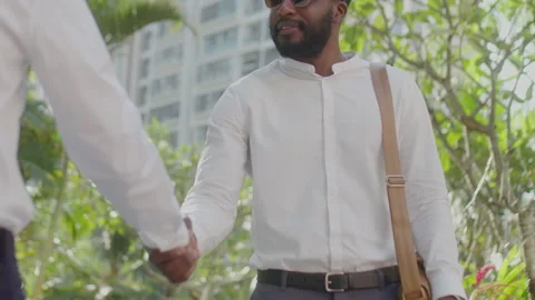 Man Using Laptop and Talking on Phone in Street Cafe Video stock 234969239