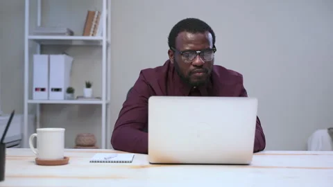 Man using laptop and writing while sitting at table at modern office spbas. Stock Footage 148947232