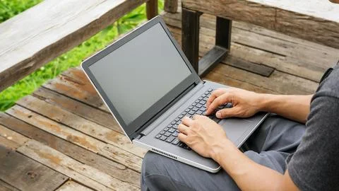 Man using a laptop on the balcony. Foto stock