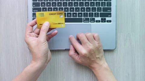 Man using a laptop computer and holding a credit card to shop online He is choos Stock Footage 232652785