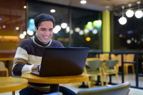 Man using laptop computer at coffee shop Stock Photos