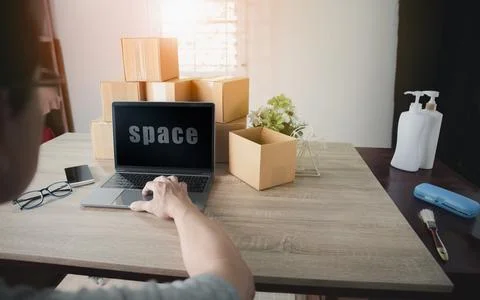 A man is using a laptop computer to do his job Stock Photos