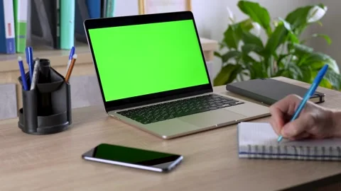A Man Using Laptop Computer With A Green Screen In The Office Stock Footage 268438911