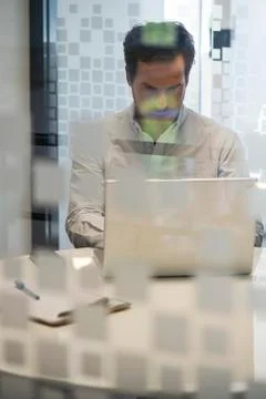 Man using laptop computer in office Stock Photos