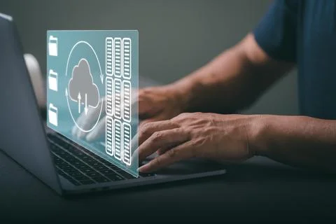 Man using the laptop computer to store important data through a cloud system Fotos Stock