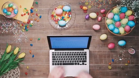 Man using laptop computer on table decorated with easter eggs Top view Stock Footage 73936998