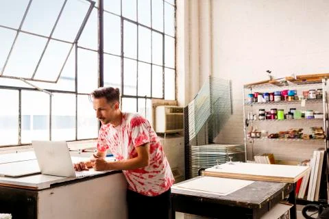 Man using laptop computer while working in workshop Foto stock