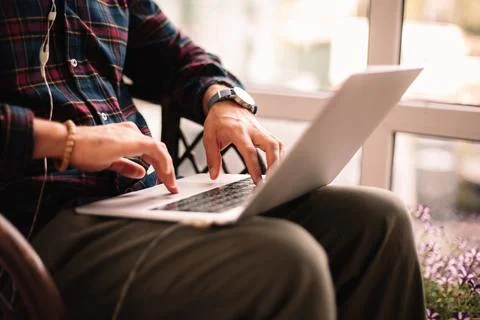 Man using laptop computer while working at home Foto stock