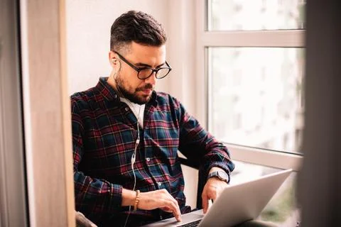 Man using laptop computer while working at home Foto stock