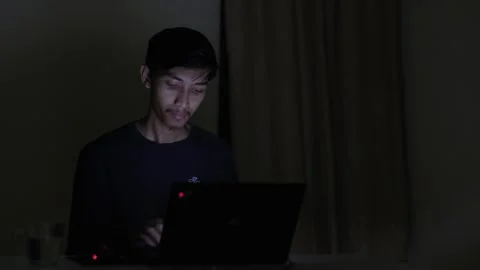 A man using laptop in the dark night room Stock Footage 276431618