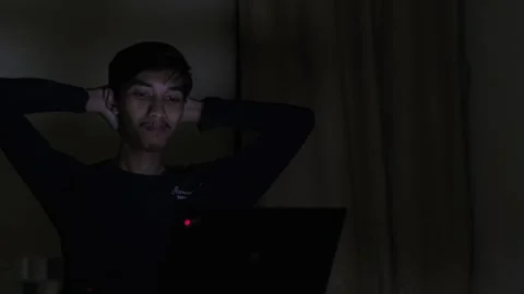 A man using laptop in the dark night room Stock Footage 276431627