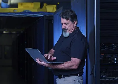 Man using laptop in data center Stock Photos