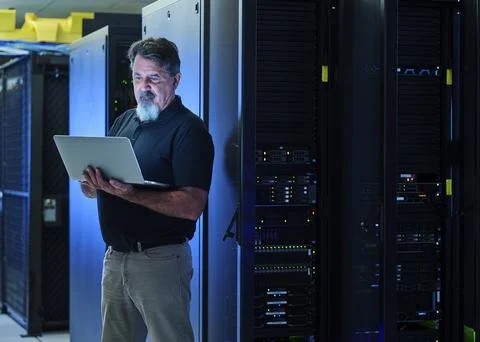 Man using laptop in data center Stock Photos