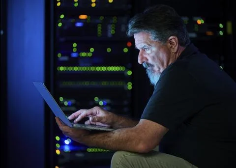 Man using laptop in data center Stock Photos