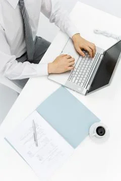 Man using laptop on desk, high angle cropped view Stock Photos
