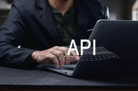 Man Using Laptop to Develop Programming Interface with API Concept Stock Photos
