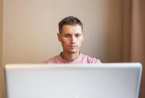 A man using laptop, for distance work at home. Stock Photos